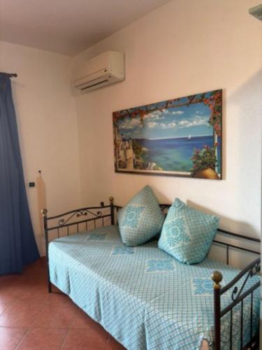 a bedroom with a bed with a picture on the wall at Marinella Residence in Santa Marinella