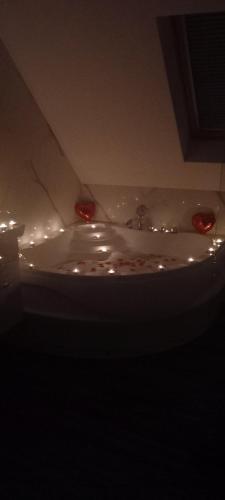 a bathroom sink with red lights on top of it at Roma Apartment in Sandanski