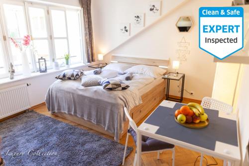 a bedroom with a bed and a table with a bowl of fruit at New Old Town Square Sdudio in Prague