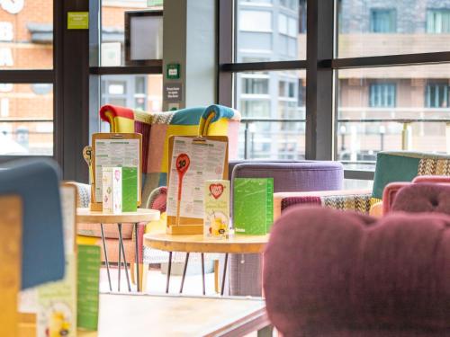 a row of tables in a room with chairs at YHA Manchester in Manchester
