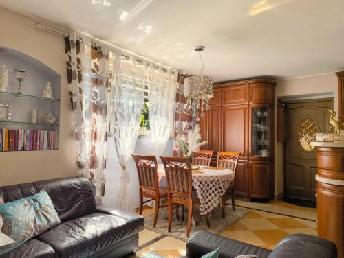 a living room with a table and chairs at MAYA apartament in Jantar