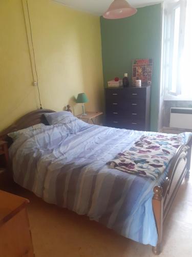 a bedroom with a large bed with a blue comforter at Yvinet in Chéniers