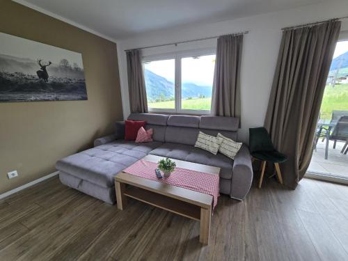 a living room with a couch and a table at Chalet Fügen in Fügen