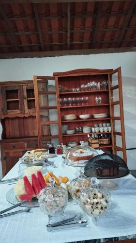 a table with a buffet of food on it at Pousada Bella Vista in Delfinópolis