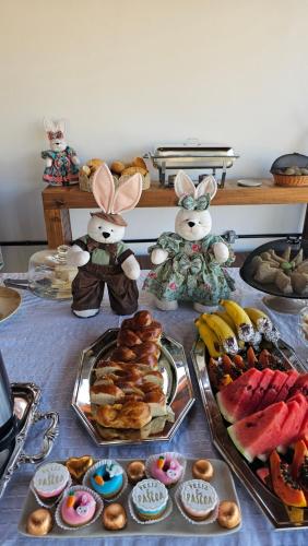 a table with many different types of pastries and fruit at Pousada Bella Vista in Delfinópolis