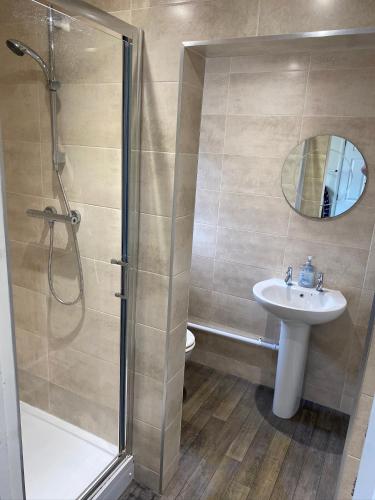 a bathroom with a shower and a sink at Albion House in Doncaster
