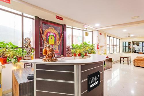 a room with a counter with plants in it at Super Collection O NAD Near Airport in Visakhapatnam