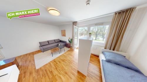 a living room with a couch and a table at Kleines Urlaubsglück, ÖPNV fußläufig erreichbar, WLAN in Chemnitz