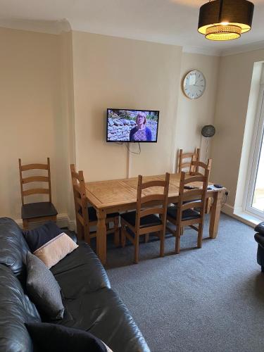 a living room with a wooden table and a couch at Albion House in Doncaster