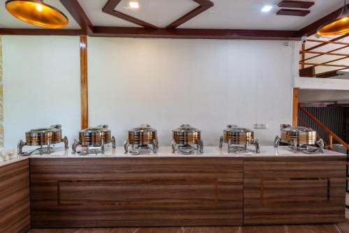 a room with a bunch of drums on display at DLS Nature Trinket Resort - Dalhousie with Swimming Pool in Dalhousie