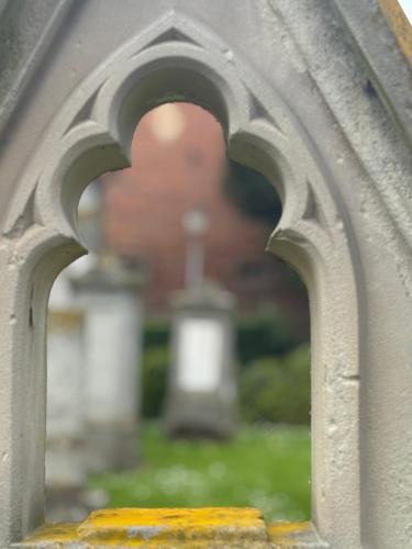 a view of a cemetery through an archway at La grange de Sophie in Berstett