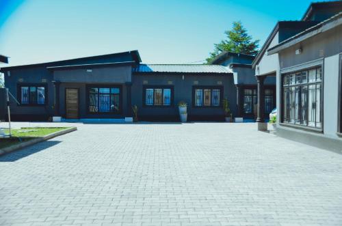 a brick driveway in front of a house at Smooth apartments and tours in Livingstone