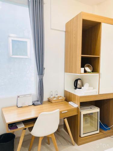 a desk with a white chair next to a window at Hello SaiGon Homestay in Ho Chi Minh City