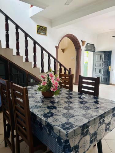 a table with a vase of flowers on top of it at bonjour villa rathgama in Rathgama