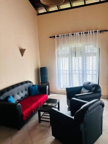 a living room with two couches and a red blanket at bonjour villa rathgama in Rathgama
