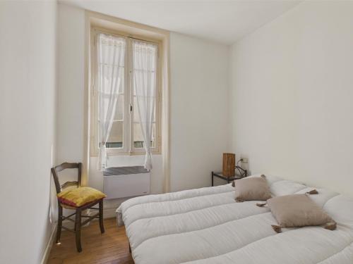 un salon avec trois canapés blancs et une fenêtre dans l'établissement Plein centre ville - maison pour 4 avec terrasse, à Sarlat-la-Canéda