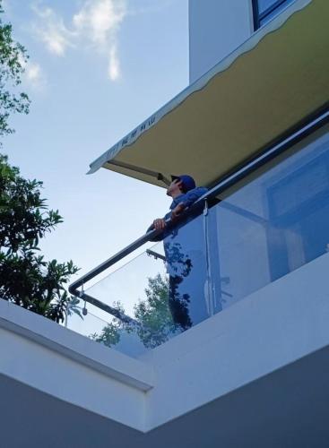 a man working on a window on a building at Eden Yard Boutique Hotel and Experiences in Xianghu