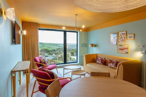 a living room with a couch and a table at SeaSpace in Newquay