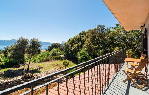 a balcony with a table and a chair on it at Stunning Apartment In Sucuraj With Wifi in Sućuraj