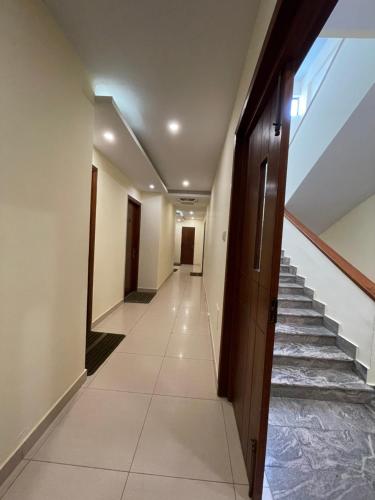 a hallway of a building with stairs and a door at Destination Beach Hotel by Dreamworld in Karachi