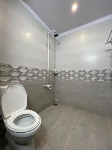a bathroom with a toilet and a shower at Destination Beach Hotel by Dreamworld in Karachi