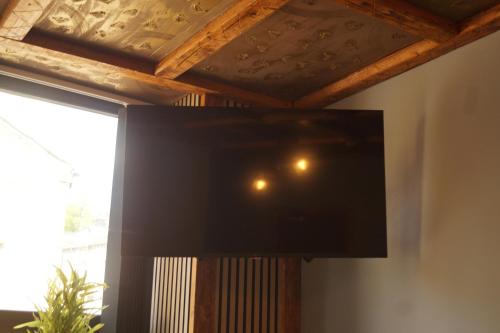 a flat screen tv hanging on a wall next to a window at The Shepherds Rest in Halifax