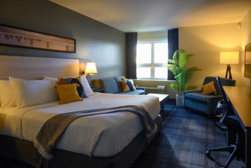 a hotel room with a bed and a couch at Rodd Miramichi in Miramichi