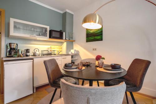 a kitchen and dining room with a table and chairs at Alte Konditorei in Lindau