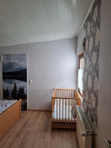 a baby room with a crib and a window at Ferienhaus Hochwald in Wadern