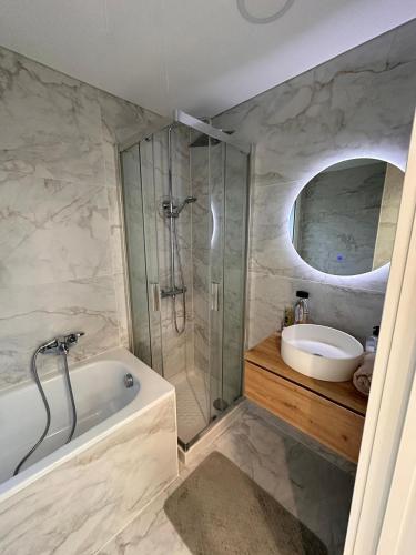 a bathroom with a shower and a tub and a sink at Villa Mont-roigh in Tarragona