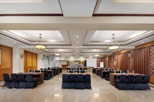 a conference room with rows of tables and chairs at Royal Hotel and Convention Tretes in Prigen