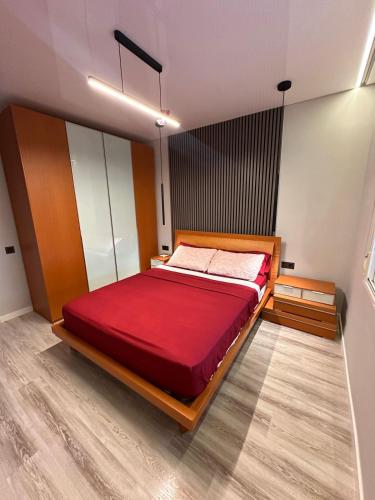 a bedroom with a large red bed in a room at Villa Mont-roigh in Tarragona