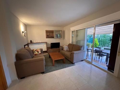 a living room with two couches and a table at Villa Mont-roigh in Tarragona