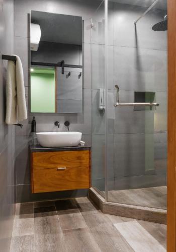 a bathroom with a sink and a shower at The Borough Lagos in Lagos