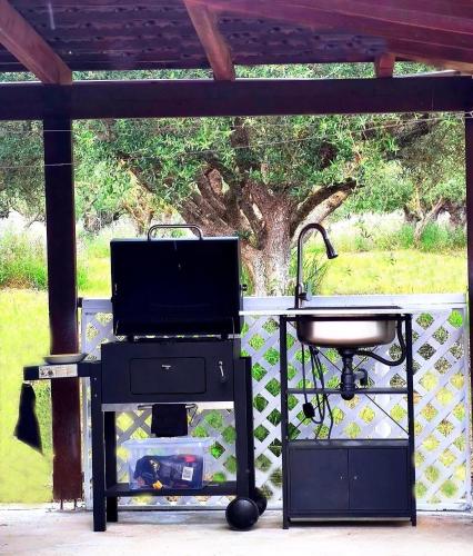 a grill and a bbq smoker with a grill at Casa Katina , villa in Lagana, Agrilia area in Laganas