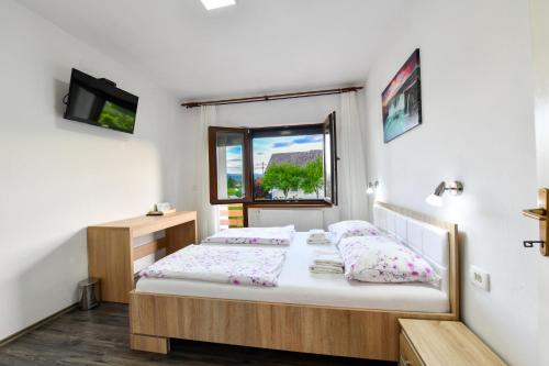 a bedroom with a bed and a window at House Turkalj in Grabovac