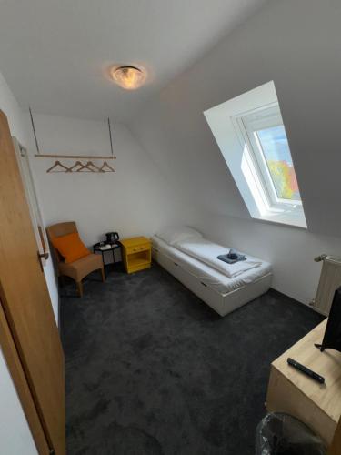 a small room with a bed and a window at Hotel Everswinkel in Everswinkel