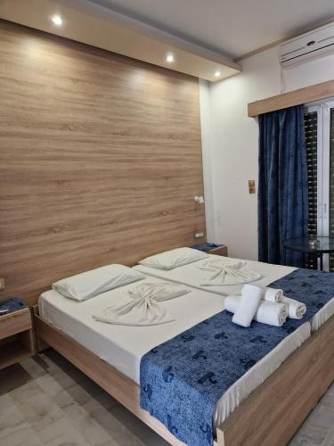 a bedroom with a large bed with two towels at Christina Studios in Kefalos