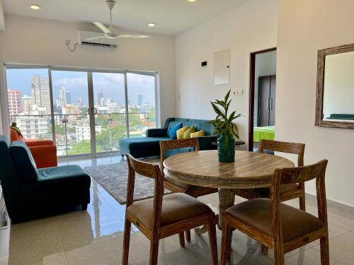 a living room with a table and chairs at 8B Flemington Colombo in Colombo