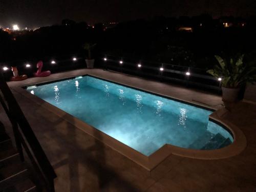 a swimming pool at night with lights at Au bien être in Bastia