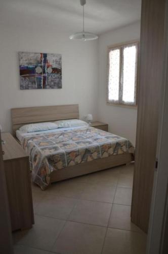 a bedroom with a bed and a window at Residenze Carlo Alberto in Castelsardo