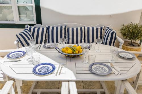 a table with blue and white plates and a bowl of fruit at 1800 MANSION in Spetses
