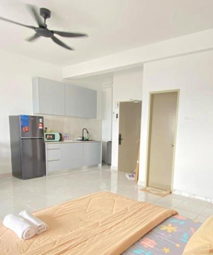 a room with a kitchen with a ceiling fan at Studio with Rooftop Pool at Youth City Nilai by D'KAY HOMES, near USIM KLIA in Nilai