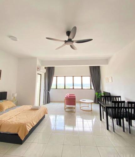 a bedroom with a bed and a ceiling fan at Studio with Rooftop Pool at Youth City Nilai by D'KAY HOMES, near USIM KLIA in Nilai