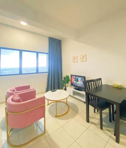a living room with a table and a dining room at Studio with Rooftop Pool at Youth City Nilai by D'KAY HOMES, near USIM KLIA in Nilai
