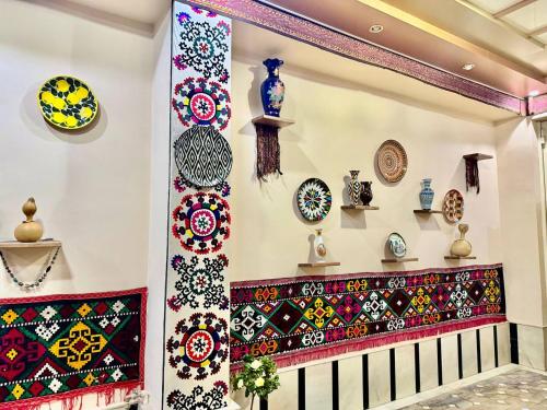 a room with colorful plates on the wall at Yusuf Gold House in Samarkand