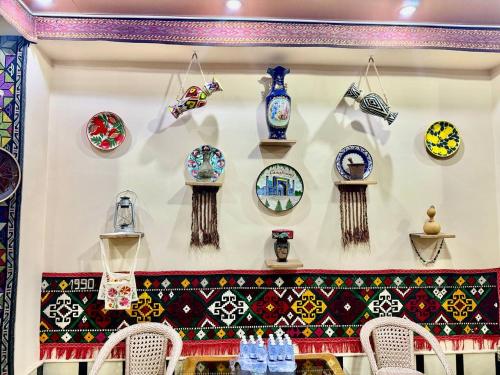 a wall with a bunch of plates on a wall at Yusuf Gold House in Samarkand