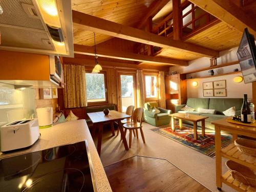 a kitchen and living room with a couch and a table at Hotel Garni Zerzer in Serfaus