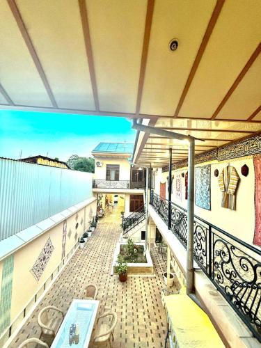 a balcony of a building with a swimming pool at Yusuf Gold House in Samarkand