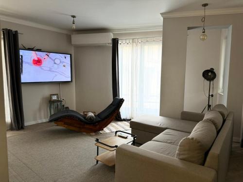 a living room with a couch and a flat screen tv at Casa Lavenda in Plovdiv